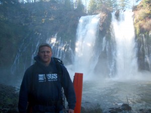 Josh Latimore standing in front of Burney Falls