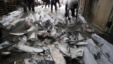 Workers cut off fins from frozen carcasses of a sharks at a fish processing plant in Kaohsiung, southern Taiwan, November 15, 2011. 