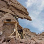 Historic preservation crew completes work on the Agnes Vaille Shelter historic structure at the Keyhole on Longs Peak, Rocky Mountain National Park Wilderness. Photographer: Sterling Holdorf, National Park Service.