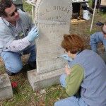 Myles Bland and Debbie Smith apply a fill patch to a repaired stone. Photo: Jason Church.