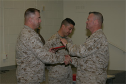 Col. Anthony F. Weddington, Combat Center inspector, presents a diploma of the equal opportunity course held aboard the Combat Center to Master Sgt. Howard E. Payne, operations chief with Marine Combat Training, School of Infantry West, Marine Corps Base Camp Pendleton, Calif.   Gunnery Sgt. Luis M. Leiva, Combat Center equal opportunity advisor, stands behind them during the ceremony.