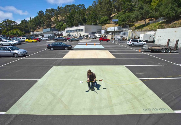 The Heat Island Group at Lawrence Berkeley National Laboratory works to cool buildings, cities, and the planet by making roofs, pavements, and cars cooler in the sun.  Here, Jordan Woods takes measurements of new cool pavement coating using a device albedometer. Other sample pavement coatings can be seen behind him. (Photo: Lawrence Berkeley National Laboratory)