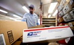 Packages wait to be sorted in a Post Office as U.S. Postal Service letter carrier of 19 years, Michael McDonald, gathers mail to load into his truck before making his delivery run. 