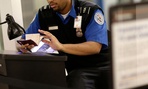 A TSA agent checks a passport at Baltimore Washington Airport.