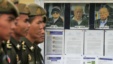 Cambodian military officials line up in front the top leaders of Khmer Rouge portraits, from right,  former Khmer Rouge Foreign Minister Ieng Sary, former Khmer Rouge head of state Khieu Samphan, and  former Deputy Secretary Nuon Chea, file photo. 