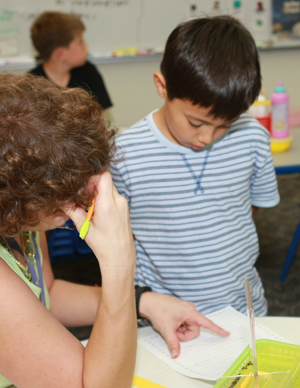 Teacher helping student