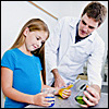 Teacher helping a girl in chemistry lab