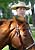 A Border Patrol Agent gets ready to begin a day of work with his horse along the Southwest Border.