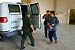 Border Patrol agents transport a prisoner who will be returned to Mexico.