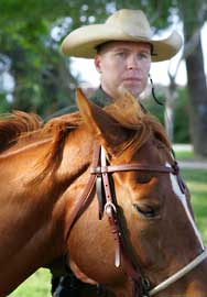 A Border Patrol Agent gets ready to begin a day of work with his horse along the Southwest Border.