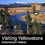 Visitors watch for wildlife along the Yellowstone River in Hayden Valley.