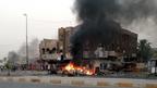 Flames rise from the site of a car bomb attack in Talibiya, Baghdad (3 September 2013)