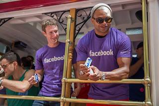 Photo: Mark Zuckerberg and NFL player Brendon Ayanbadejo ride the Facebook Pride trolley. (Photo Credit: Jason Agron Photography)