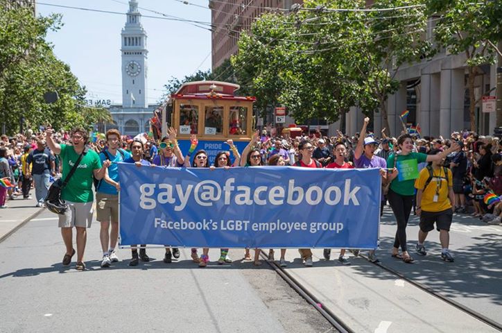 Photo: A group of interns selected to carry the banner lead the company's contingent through the parade route. (Photo Credit: Jason Agron Photography)