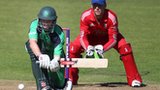 William Porterfield is about to attempt a sweep shot as England wicketkeeper Jos Buttler crouches behind the stumps