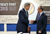 Date: 09/25/2013 Description: U.S. Secretary of State John Kerry, left, shakes hands with Under Secretary-General for Legal Affairs Miguel Serpa Soares after signing the Arms Trade Treaty during the 68th session of the United Nations General Assembly at UN headquarters. (AP Photo/Jason DeCrow) © AP Image