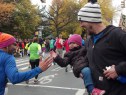 A young girl cheers on marathon runners in Manhattan. (credit: Marla Diamond)