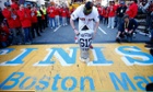 Boston Red Sox outfielder Jonny Gomes places the World Series trophy at the finish line of the Boston Marathon to honor the victim's of April's deadly bombings.