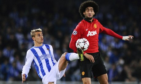 Marouanne Fellaini of Manchester United disputes possession with Real Sociedad's Antoine Griezmann.