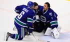 Vancouver Canucks goaltender Roberto Luongo tafter getting hit in the neck with a puck against the Boston Bruins