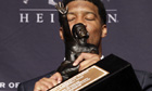 Jameis Winston holds the Heisman Trophy