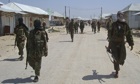 MDG : Somalia : Al-shabab recruits walk down a street 