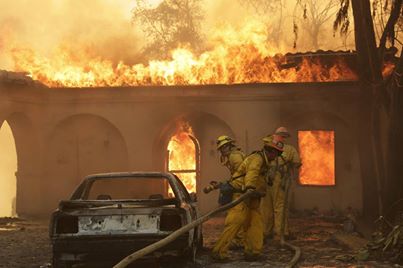 Photo: Photos: Southern California's notorious Santa Ana winds fanned a fire in the foothills of the San Gabriel Mountains that quickly grew out of control this morning, forcing nearly 2,000 people to evacuate their homes in pre-dawn darkness. Embers were seen igniting palm trees in yards and ash rained down on Los Angeles, with at least two homes destroyed in the city of Glendora. http://yhoo.it/1dbhtZ5