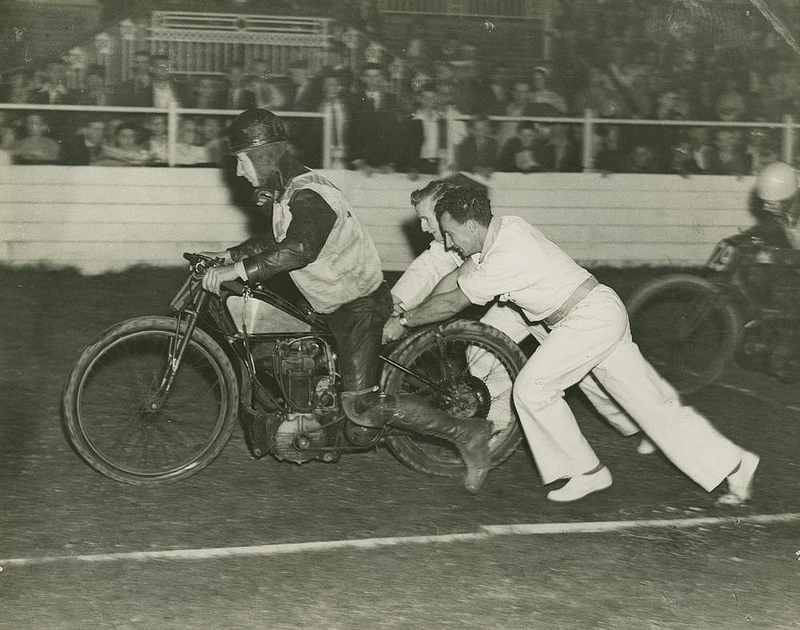 Motor bike racer getting a push start at the track, Brisbane