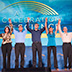 Photo of a family group holding hands on stage at the Celebration of Science.