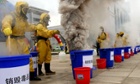 Chinese workers in protective gear destroy 500kg of confiscated drugs. There are around 700,000 heroin addicts in China and last year, 298,000 people were treated in compulsory drug treatment centres and 70,000 were sent to "re-education-through-labor" camps.