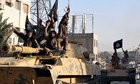 Isis fighters during a parade in Raqqa, Syria