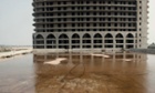 Commercial and office buildings under construction in Caofeidian ecological city, Hebei, China on 17 July 2014. The ecological city within the zone built through land reclamation, was made possible through huge bank loans but after being half built, all bank loans were halted and projects suspended due to rising costs of raw materials and a lack of government support.