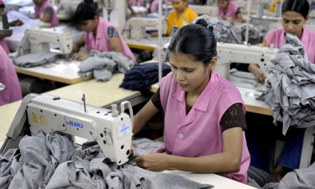 Bangladeshi garment workers sew T-shirts at a factory in Dhaka.