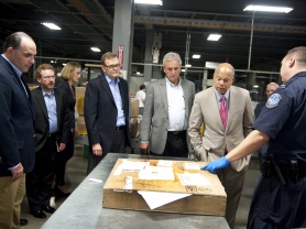Secretary Johnson inspects incoming international packages at UPS Worldport Facility with UPS Vice President of Government Affairs Norm Schenk and UPS Chief Operating Officer and incoming Chief Executive Officer David Abney