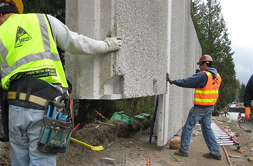 Crews lift panel into place