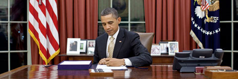 President Obama sitting in the Oval Office