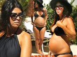 EXCLUSIVE: **PREMIUM RATES APPLY STRICTLY NO WEB** Pregnant Kourtney Kardashian relaxes pool-side in a bikini Los Angeles......Ref: SPL847827  220914   EXCLUSIVE..Picture by: Splash News....Splash News and Pictures..Los Angeles: 310-821-2666..New York: 212-619-2666..London: 870-934-2666..photodesk@splashnews.com..