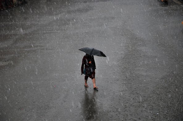 A commuter making her way during a downpour in the northern hill station of Shimla, Himachal Pradesh.