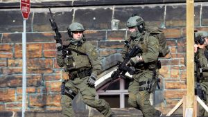 A Royal Canadian Mounted Police intervention team responds to a reported shooting at Parliament building in Ottawa, Wednesday, Oct. 22, 2014. A soldier standing guard at the National War Memorial has been shot by an unknown gunman and there have been reports of gunfire inside the halls of Parliament.