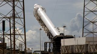 Space Exploration Technologies' Falcon 9 rocket is prepared for a launch attempt from Space Launch Complex 40 at the Cape Canaveral Air Force Station in Cape Canaveral, Florida October 7, 2012. The firm, also known as SpaceX, the first private company to fly to the International Space Station, is poised to launch its initial cargo mission to the orbital outpost as part of a $1.6 billion contract with NASA to deliver supplies. Liftoff of the company's Falcon 9 rocket and Dragon capsule is scheduled for 8:35 p.m. EDT on Sunday (0035 GMT Monday) from Cape Canaveral Air Force Station in Florida.