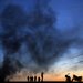 Kurdish refugees near Turkey's border with Syria on Oct. 26, as smoke rises over Kobani in the distance.