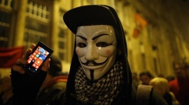 A protester holds his mobile phone during a protest against new tax on Internet data transfers in the center of Budapest, October 28, 2014.   REUTERS/Laszlo Balogh 