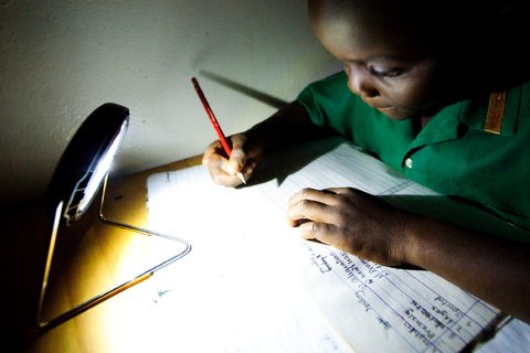 A schoolboy in Zambia's Chadiza district  does his homework with the help of a solar lantern that can provide up to eight hours of light on a single day's charge. Crowdfunding helped finance a project to distribute lights to people living off the grid there.