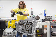 Work on a Volt drive unit at a General Motors plant in Michigan. G.M. says the new Volt will go farther on a battery charge.