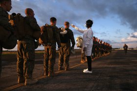 A health worker takes the temperature of U.S. Marines arriving to take part in Operation United Assistance on Oct. 9, 2014 near Monrovia, Liberia.