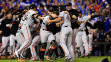 Buster Posey #28 and Madison Bumgarner #40 of the San Francisco Giants celebrate after defeating the Kansas City Royals to win Game Seven of the 2014 World Series by a score of 3-2 at Kauffman Stadium on October 29, 2014 in Kansas City, Missouri.  (Photo by Jamie Squire/Getty Images)