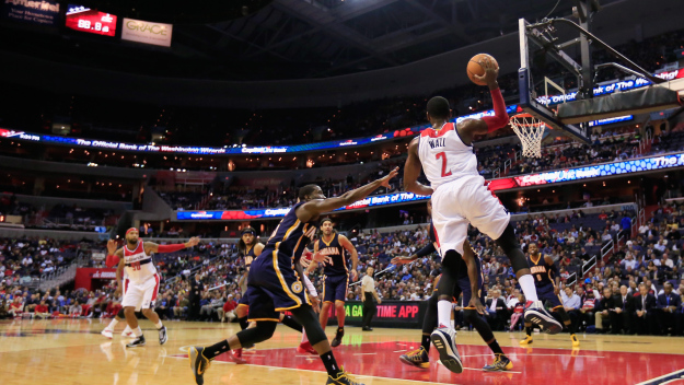 WASHINGTON, DC - NOVEMBER 05: John Wall #2 of the Washington Wizards passes the ball against the Indiana Pacers during the first half at Verizon Center on November 5, 2014 in Washington, DC.  (Photo by Rob Carr/Getty Images)