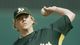 Oakland Athletics starting pitcher Brad Halsey warms