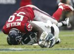 Houston Texans outside linebacker Whitney Mercilus (59) sacks Philadelphia Eagles quarterback Nick Foles (9), knocking him out of the game, during the first half of an NFL football game at NRG Stadium,Sunday, Nov. 2, 2014, in Houston.