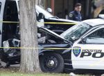 Police work the scene of an officer-involved shooting in the 5300 block of Mangum, Wednesday, Nov. 12, 2014, in Houston. Police arrested a man after he allegedly stole an officer's car from the Lisa Motel in the 10600 block of Hempstead Highway, and crashed it into a tree along Mangum.